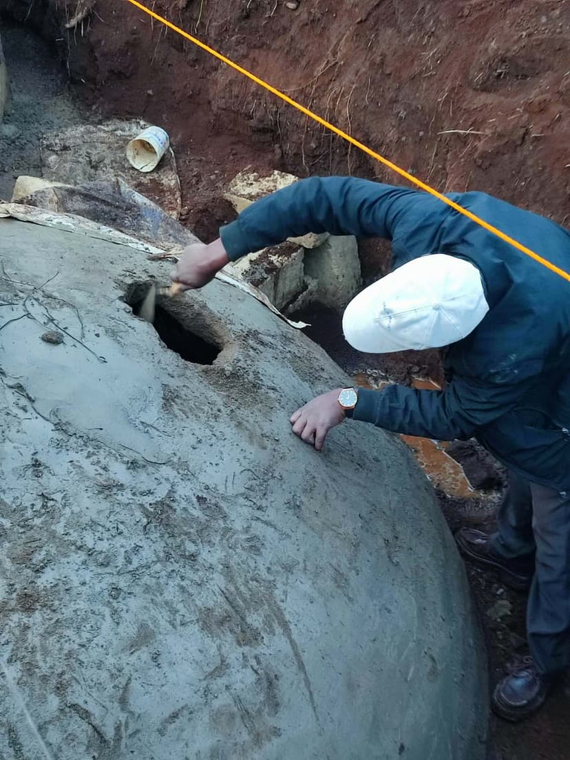 Technician cutting the inspection hatch into a digester dome