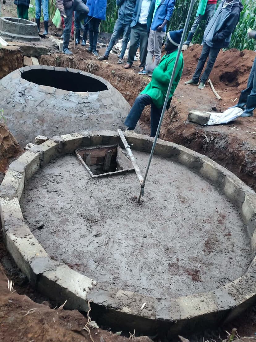 Two completed digester tanks with inspection hatch visible