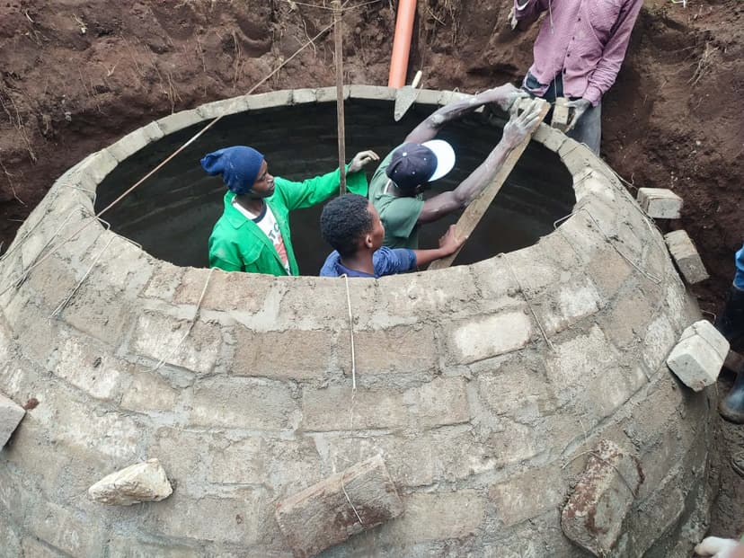 Technicians working inside a partly-built digester dome